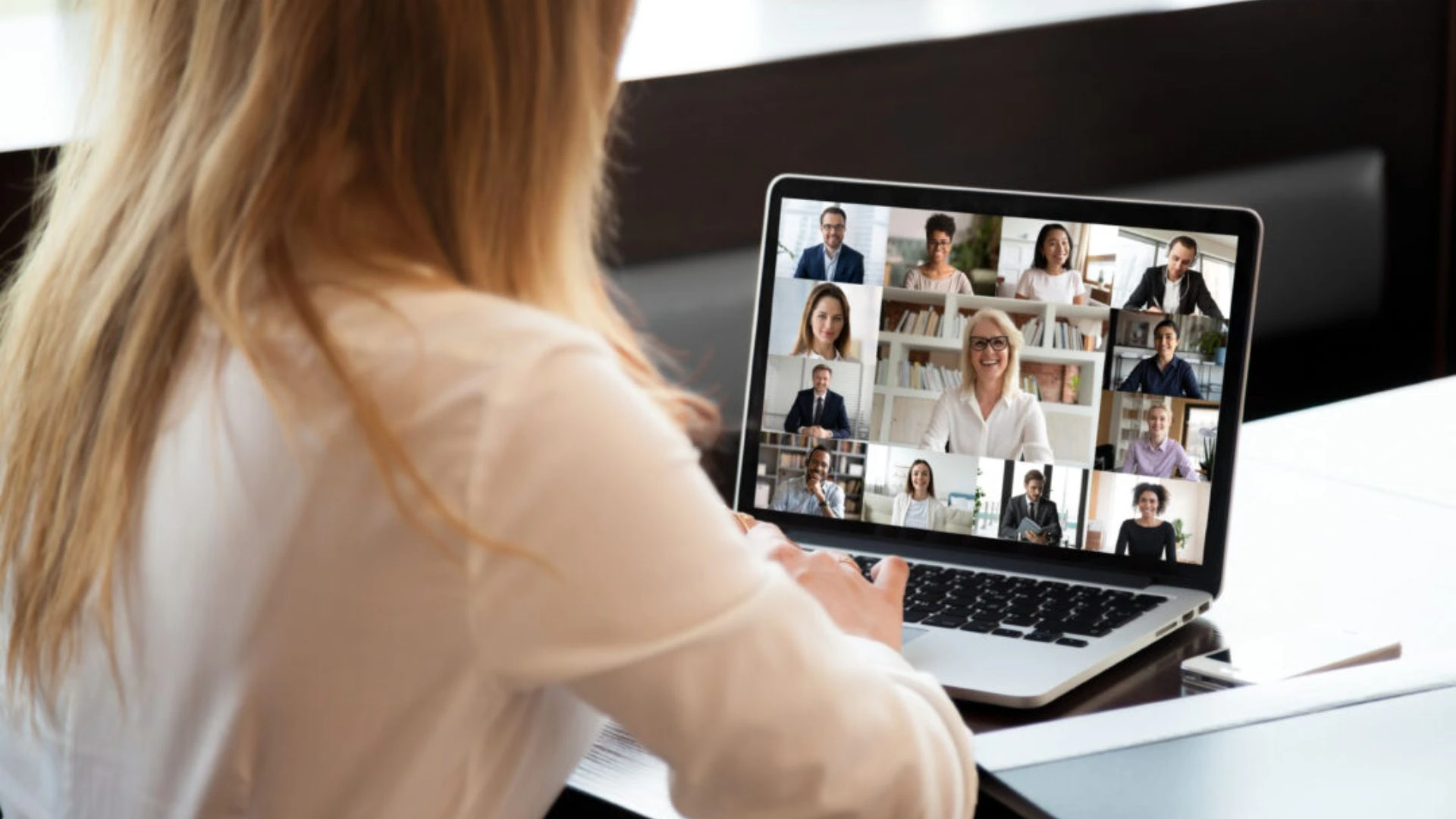 Manager leading a virtual team meeting