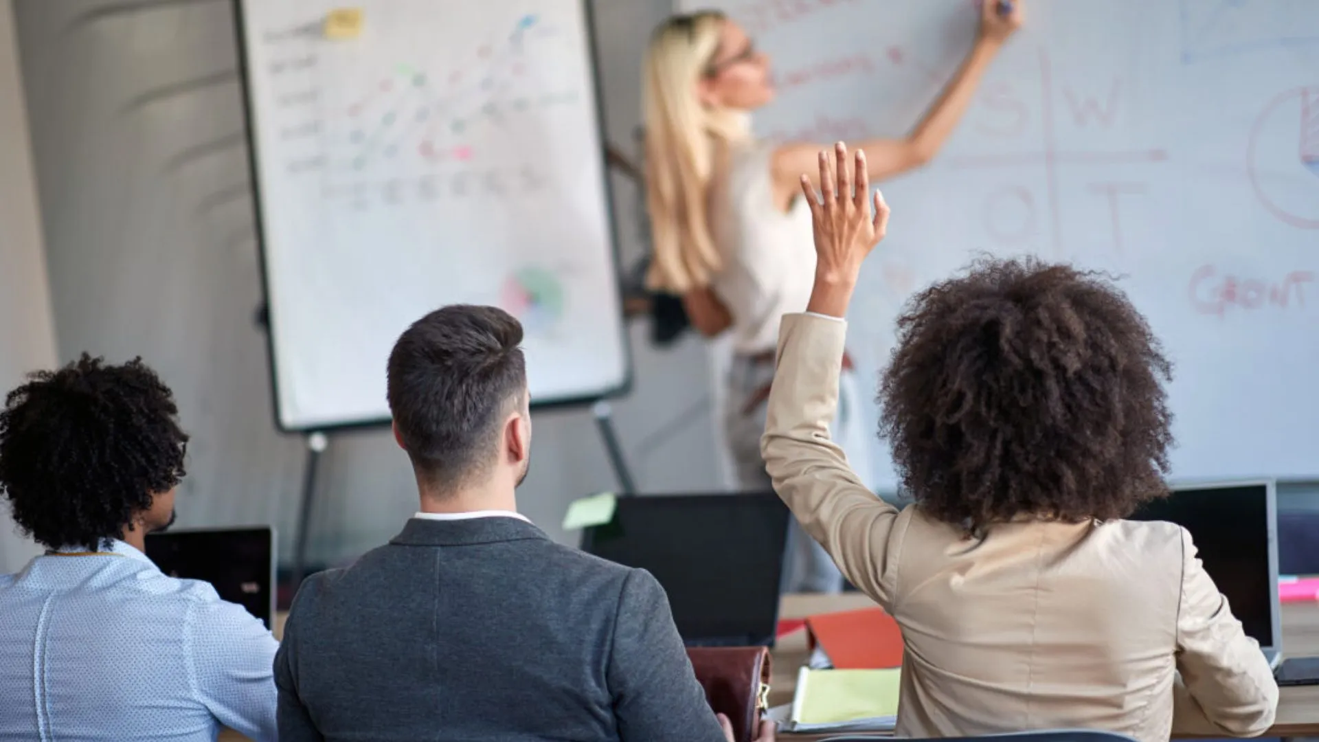 Person raising her hand in a presentation
