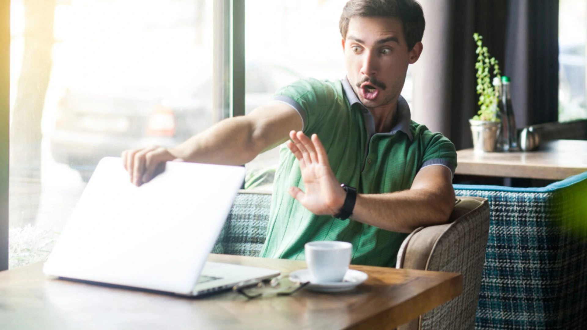 Person closing laptop in horror