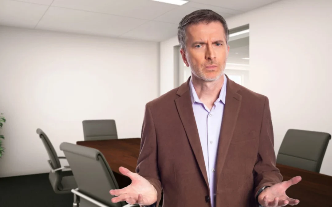 Man in a boardroom looking confused