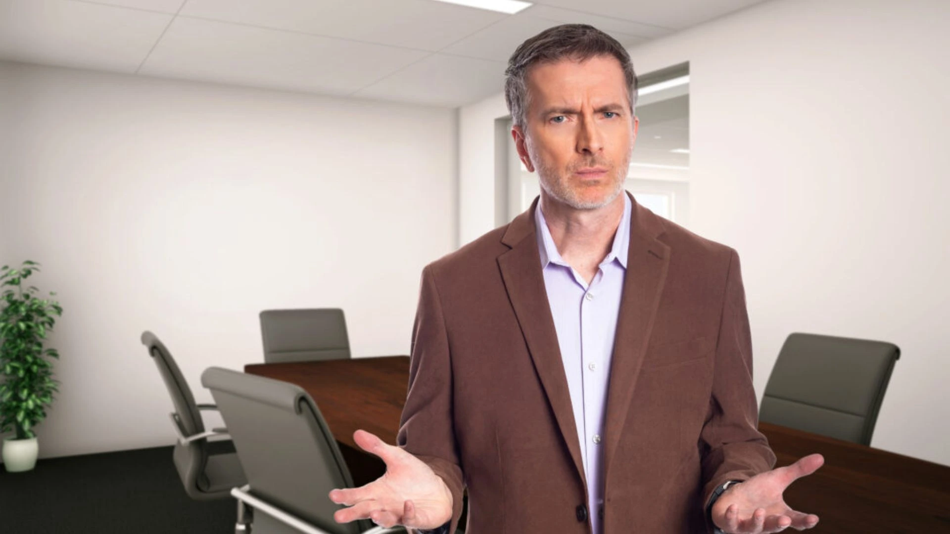 Man in a boardroom looking confused