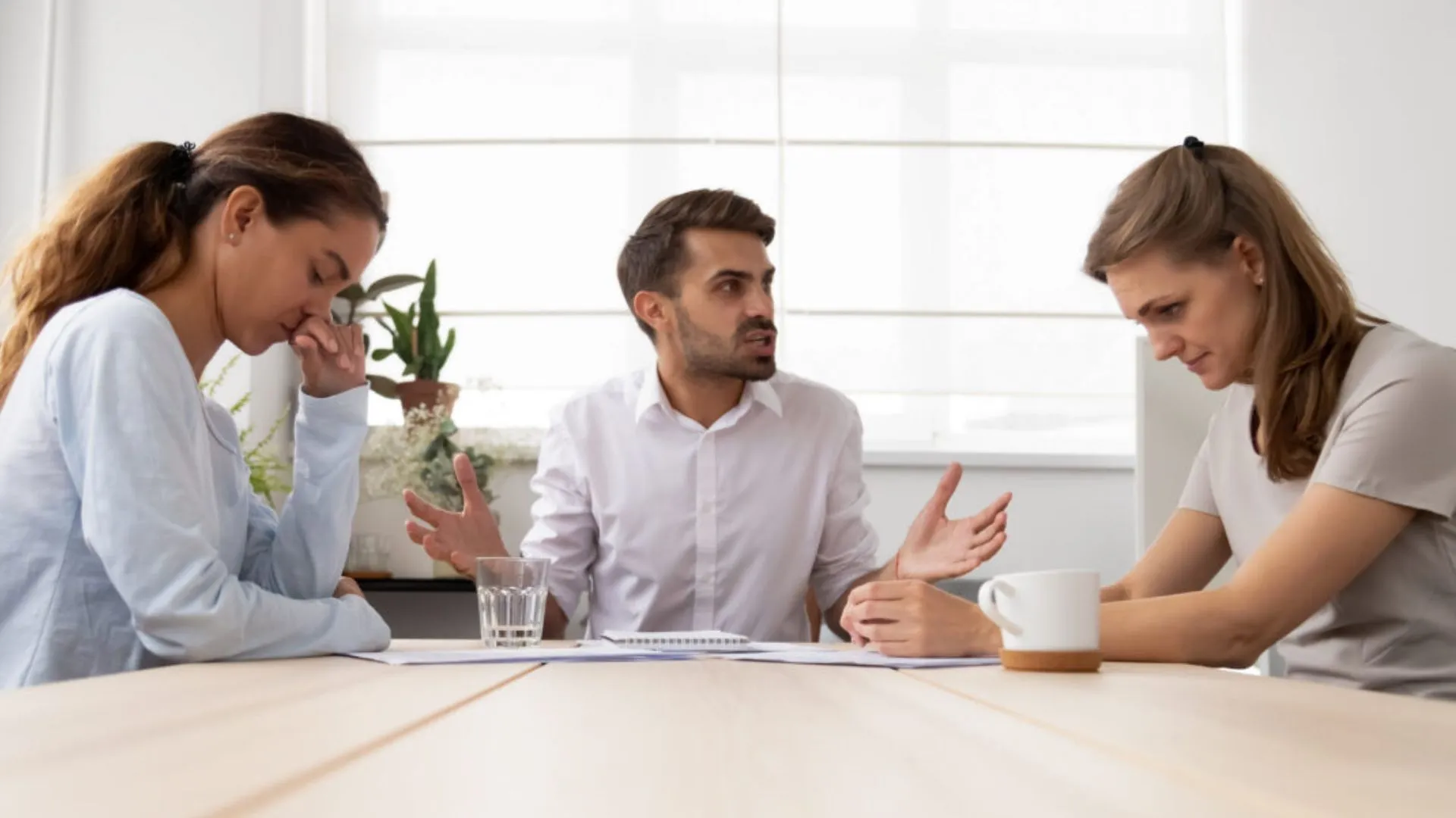 Annoying man meeting with two colleagues