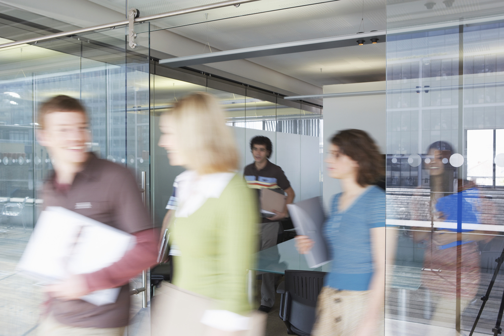 Blurred photo of people rushing out of a meeting