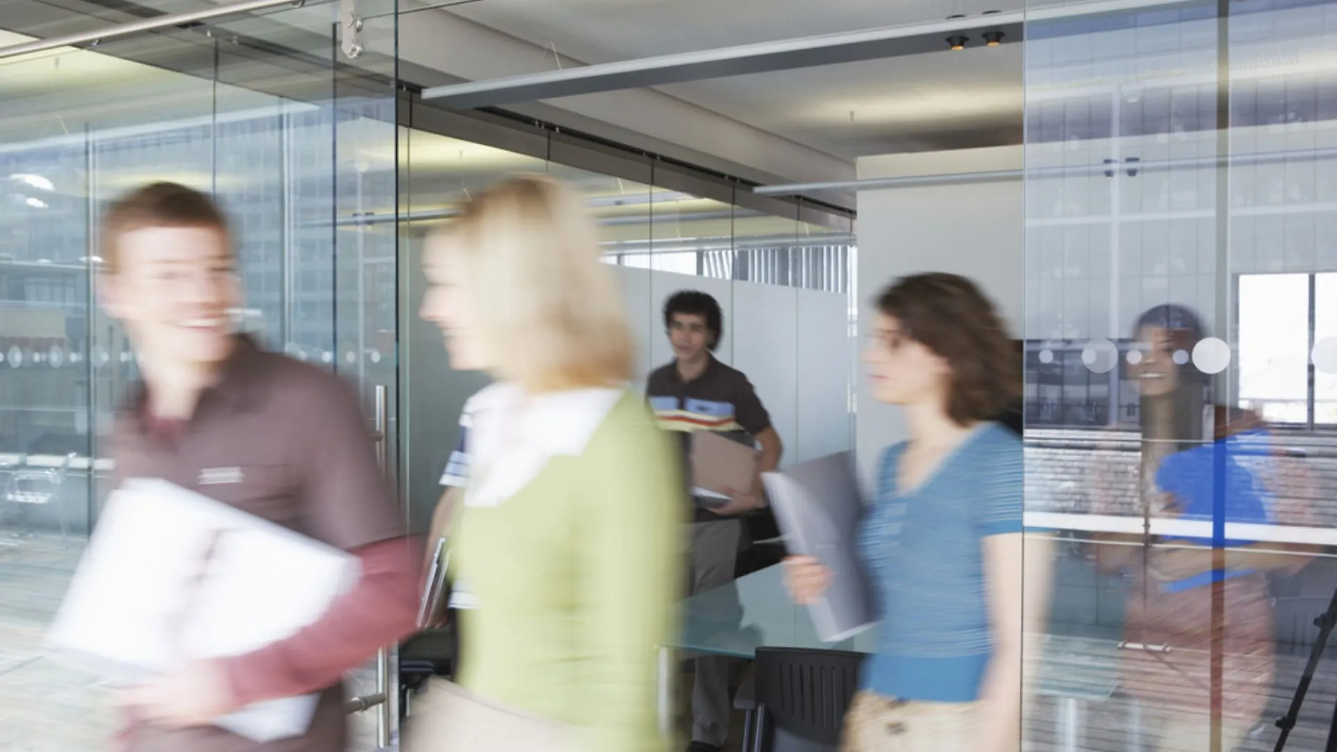 Blurred photo of people rushing out of a meeting