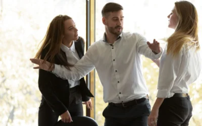 Man getting in between two fighting colleagues