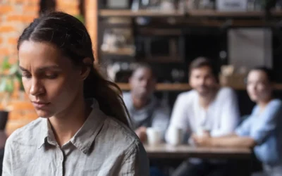 Woman with her back to her team looking pensive