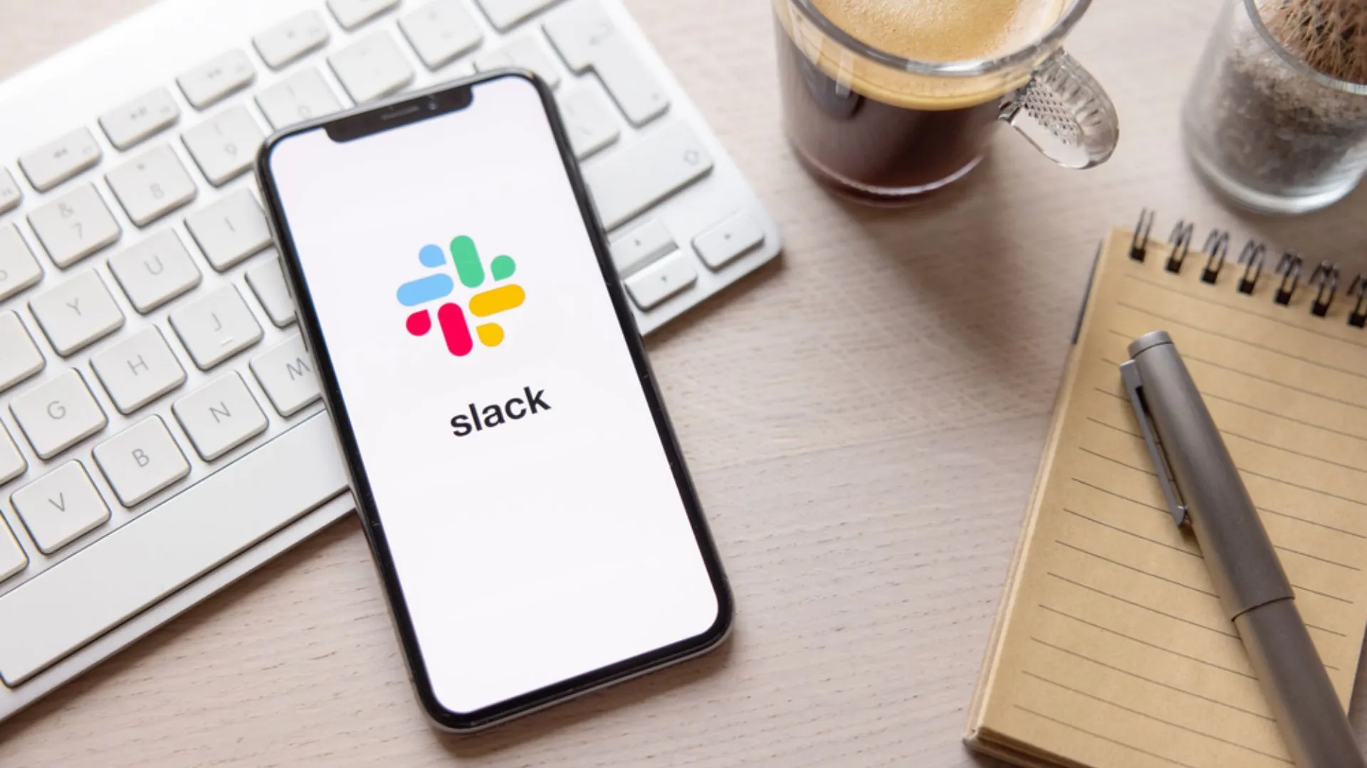Phone showing the Slack app sitting on top of keyboard