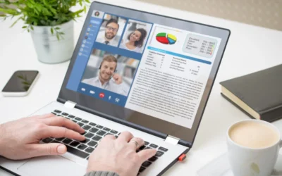 Person collaborating with teammates in a virtual environment over a laptop