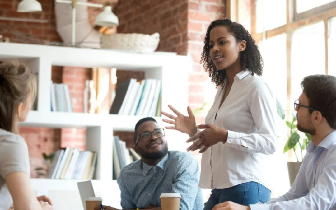 Woman standing and addressing a team in a meeting