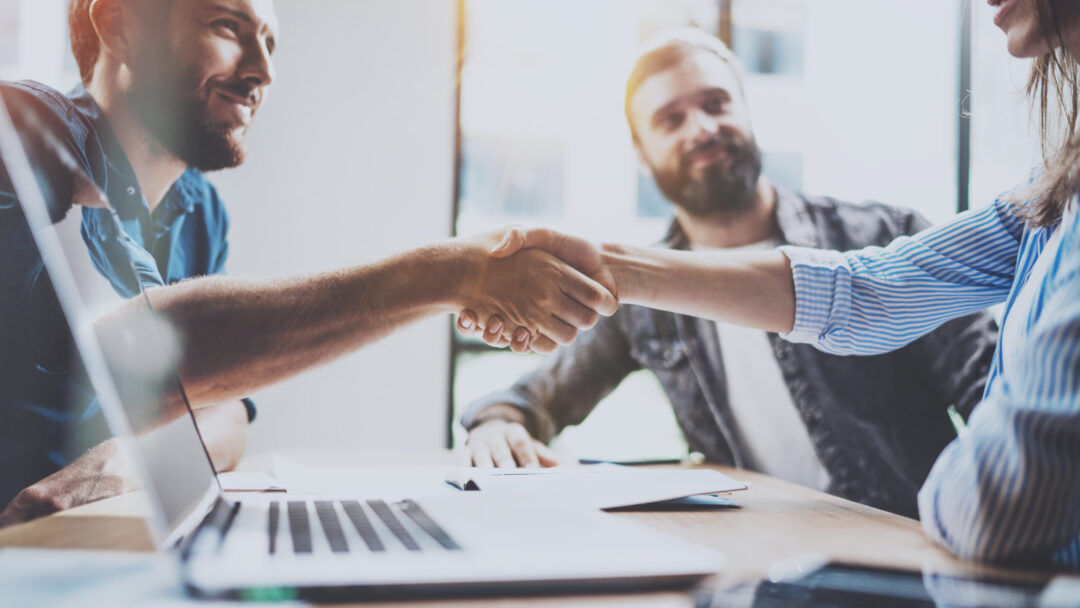 Team members shaking hands.