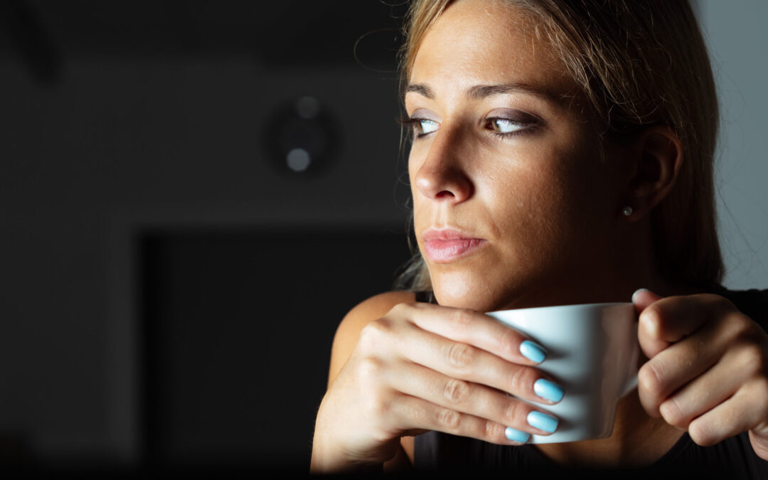 Woman drinking a coffee and looking pensive