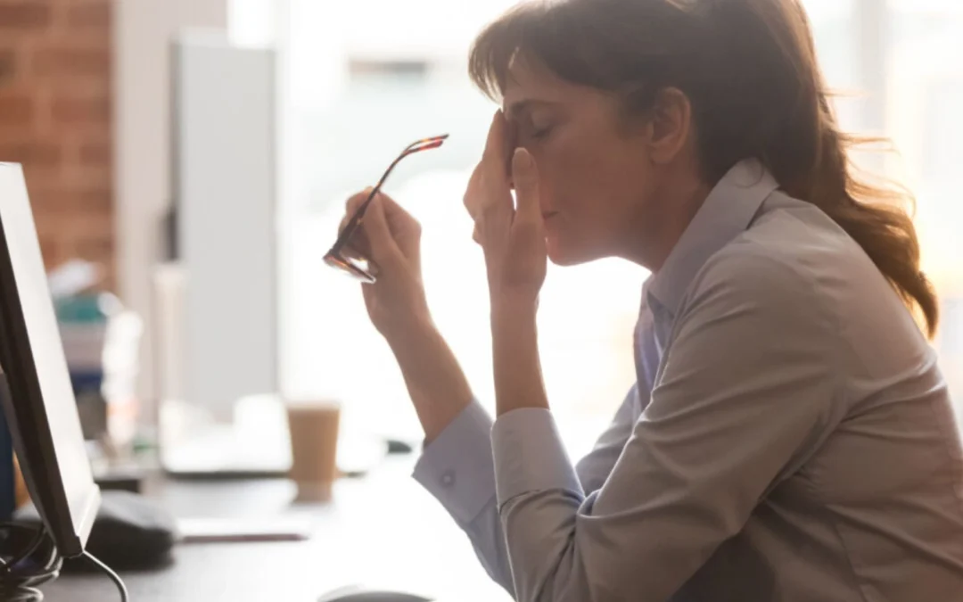 Women taking off her glasses and rubbing her face