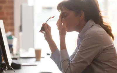 Women taking off her glasses and rubbing her face