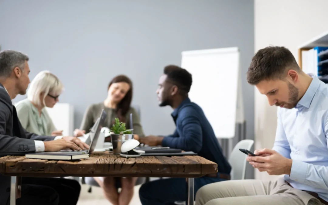 Person looking at their phone in a meeting