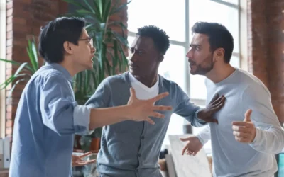 Two coworkers arguing and one trying to intervene