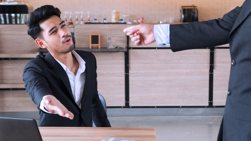 Colleagues pointing the finger of blame at each other.