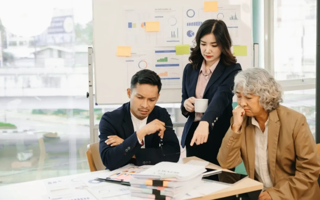 Team in front of a white board covered in data looking frustrated