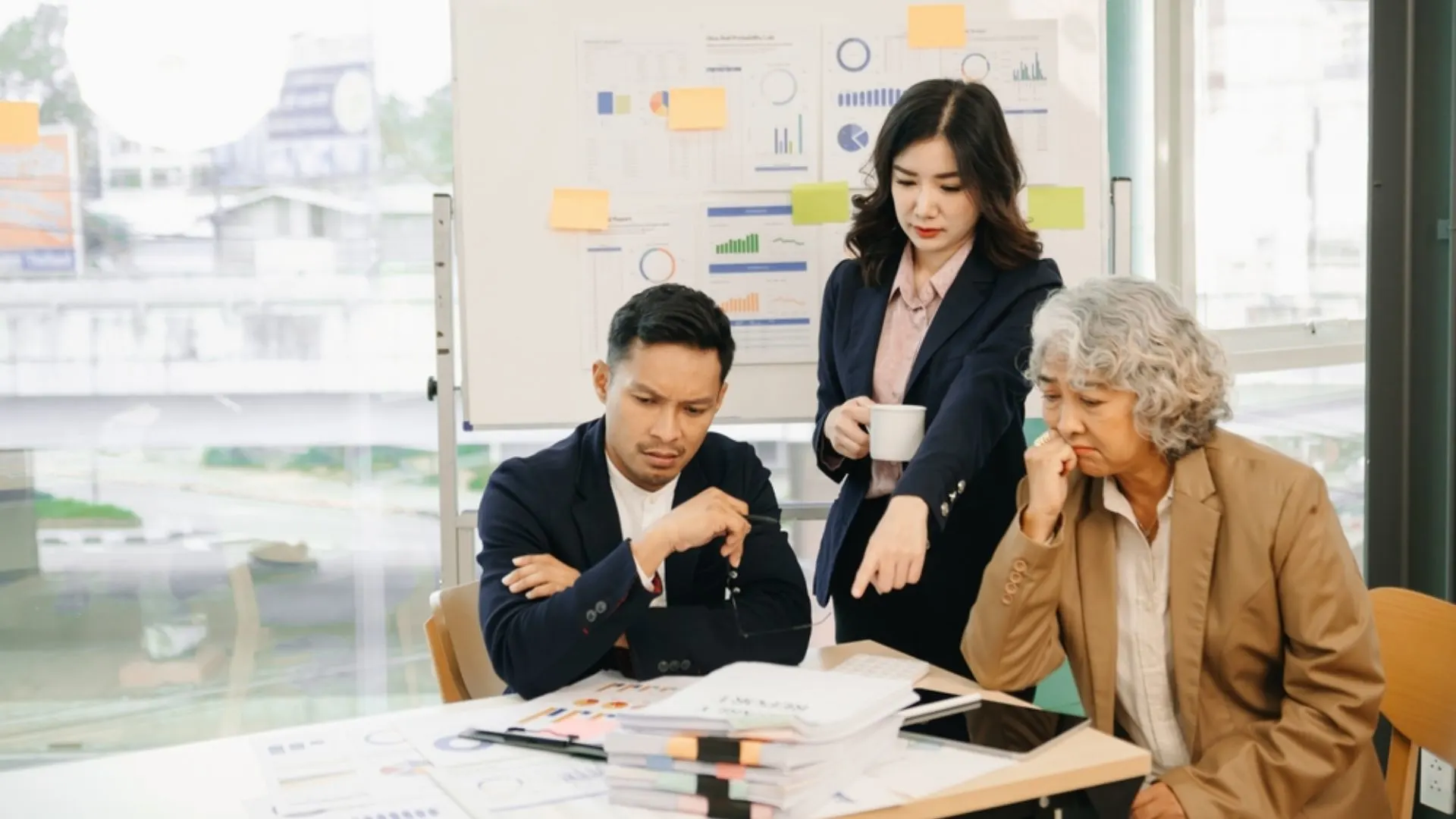 Team in front of a white board covered in data looking frustrated