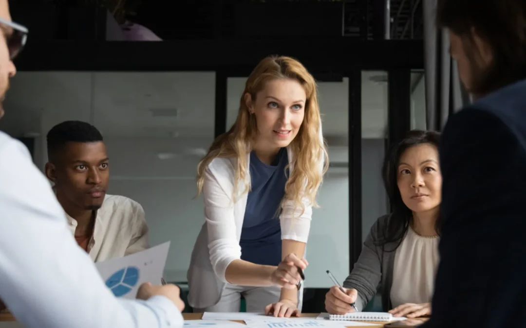 Woman leaning over a table leading a discussion