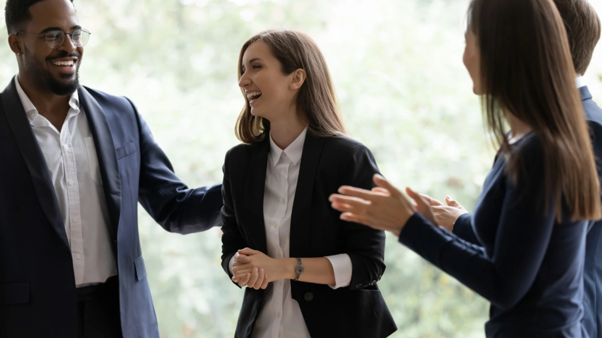 Team clapping for a colleague