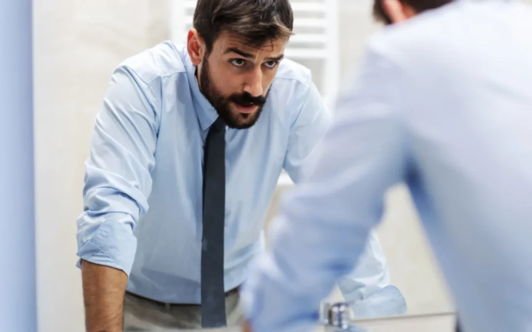 Business person looking in the mirror