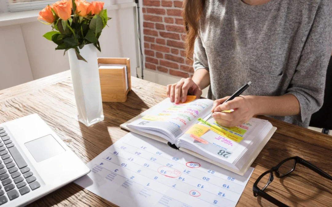 Person planning out weekly calendar and tasks