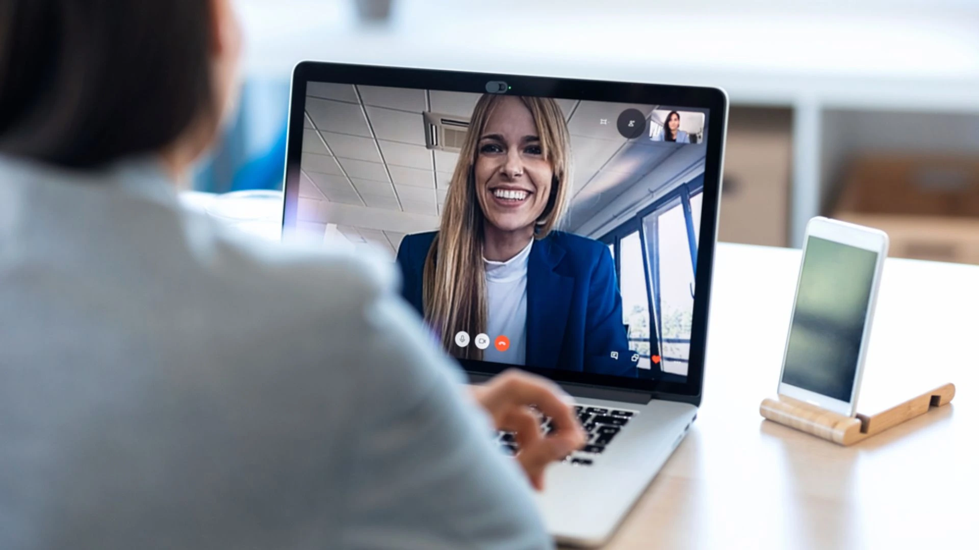Two colleagues talking over a video call