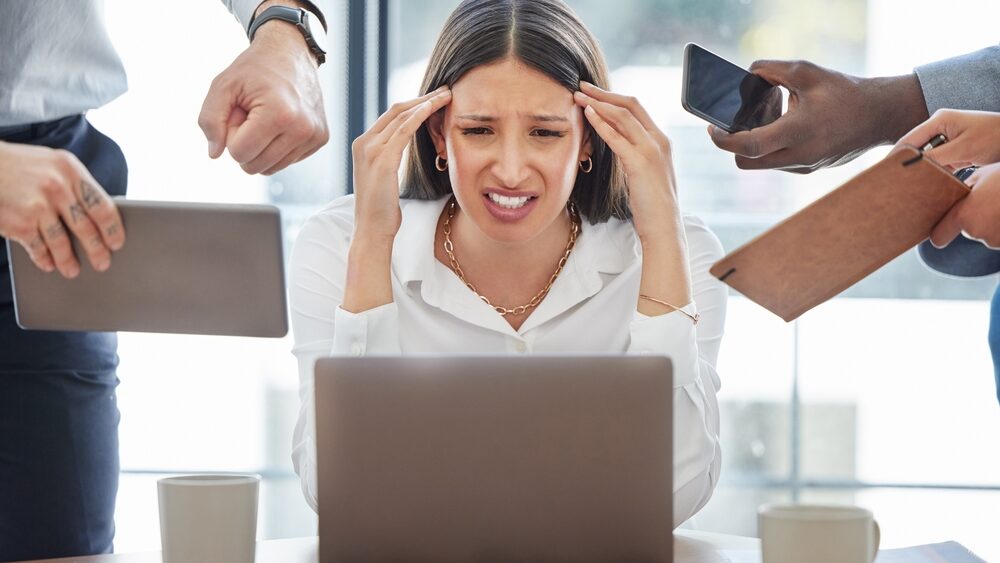 Woman getting stressed from multitasking