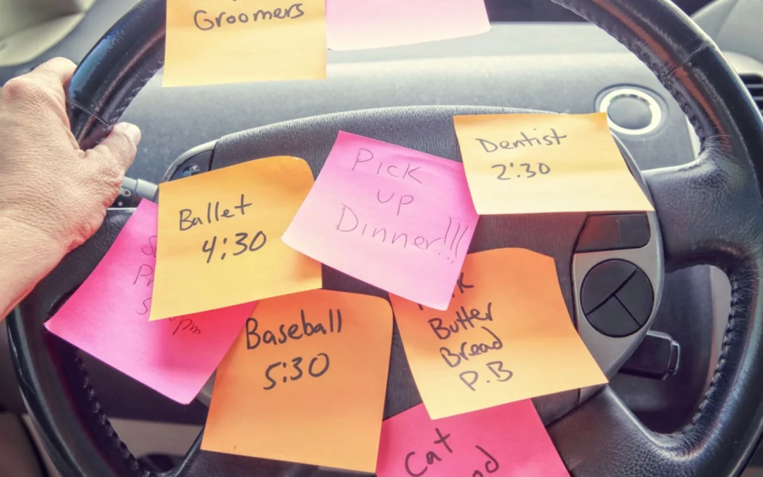Steering wheel covered in post it notes with tasks