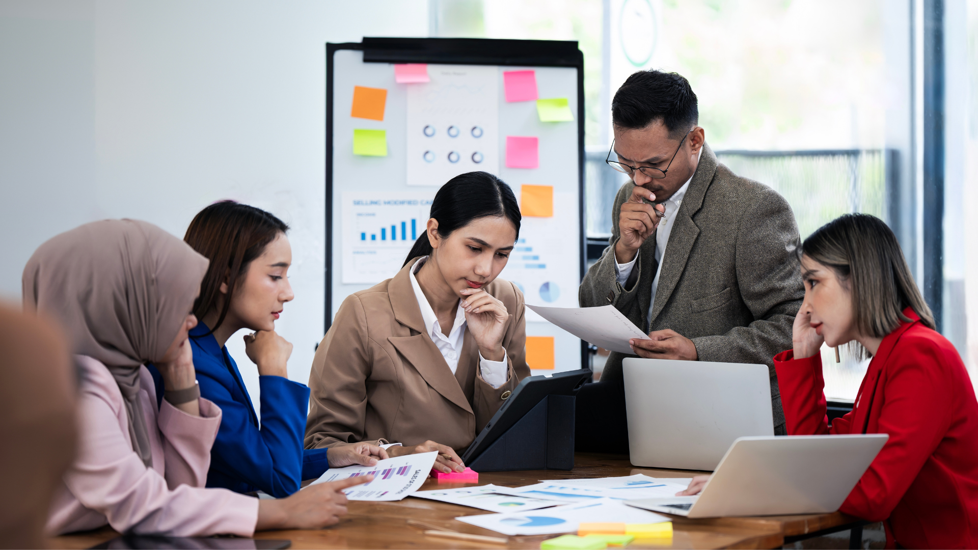 Team sitting around a table looking confused