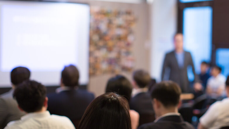 Leader giving a presentation to a large group of people