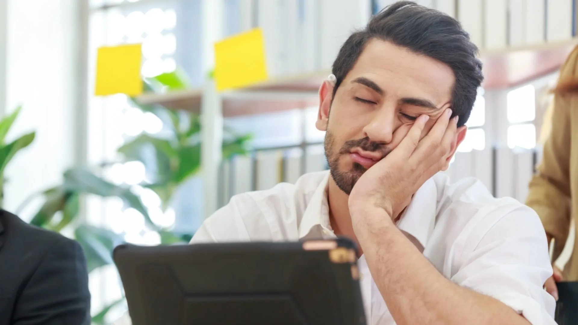 Man struggling with energy management in a meeting
